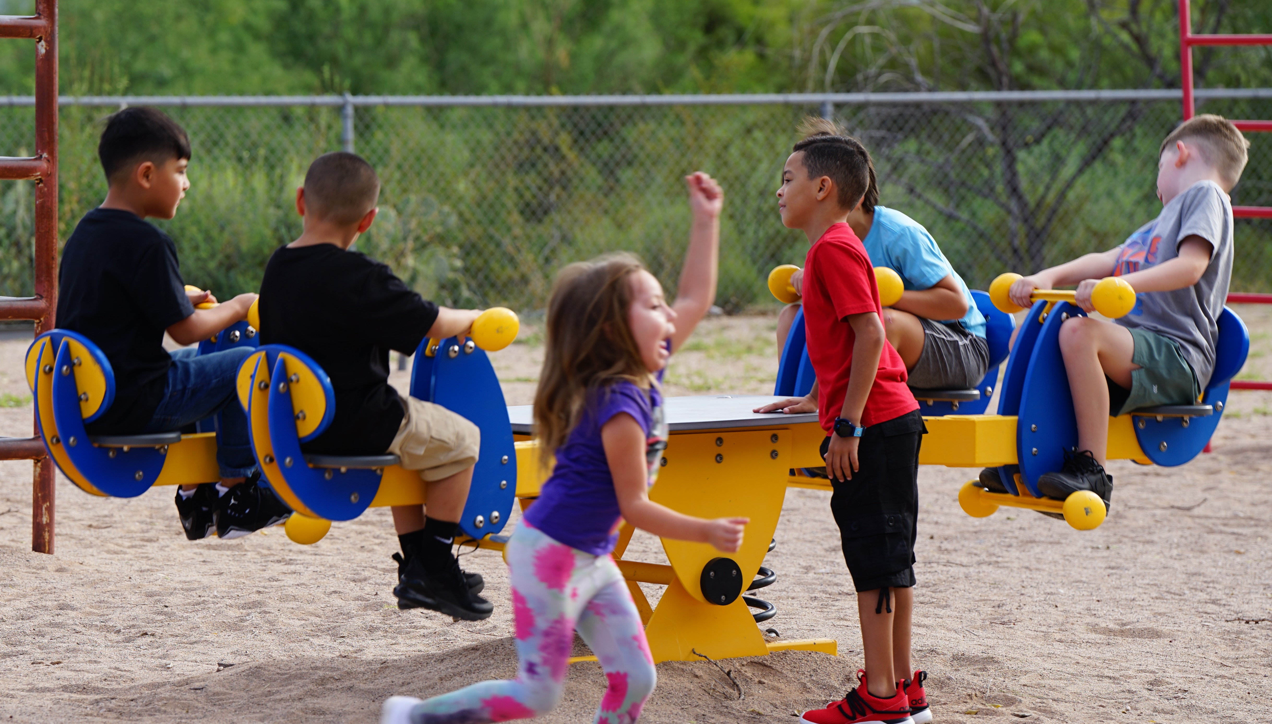 Kids play on the playground equipment at recess