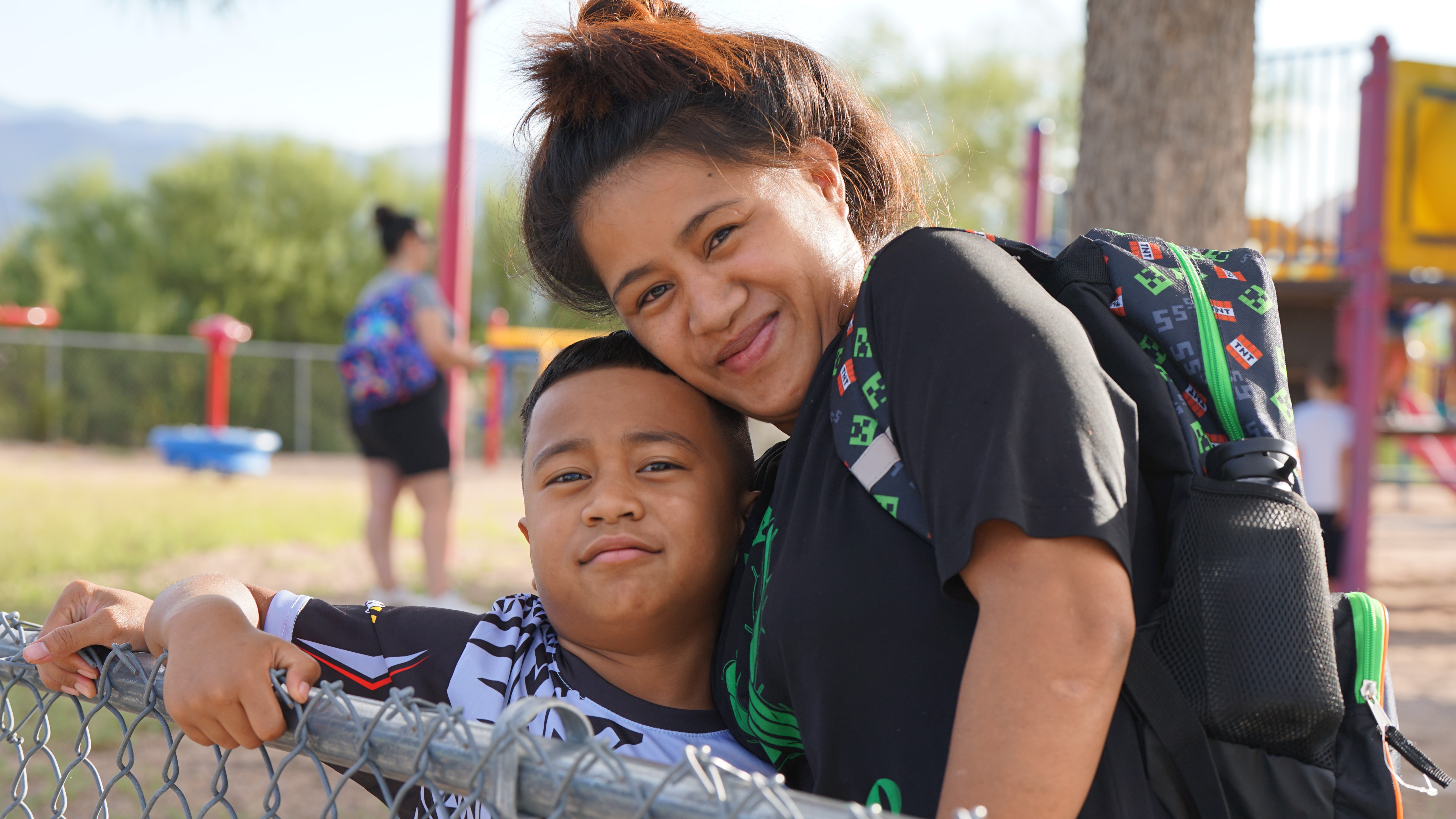 A mom hugs her son on the second day of school